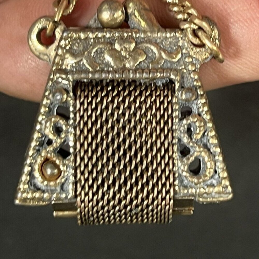 Dainty purse pend/charm! Gold tone opening vintage purse with convenient clip.
